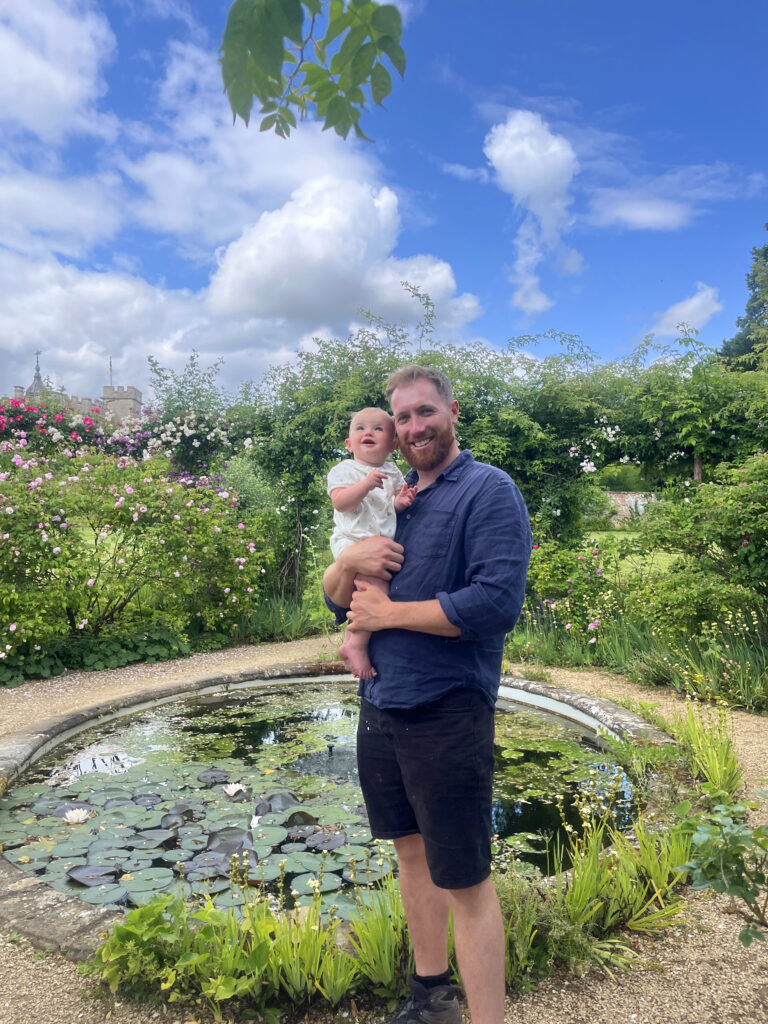 Gardener Dom Ford holding his baby