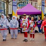 Pancake racegoers in fancy dress on high street